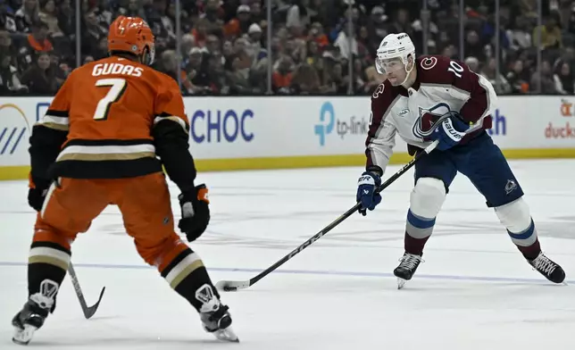 Colorado Avalanche center Charlie Coyle (10) controls the puck with Anaheim Ducks defenseman Radko Gudas (7) defending during the second period of an NHL hockey game in Anaheim, Calif., Sunday, April 13, 2025. (AP Photo/Alex Gallardo)