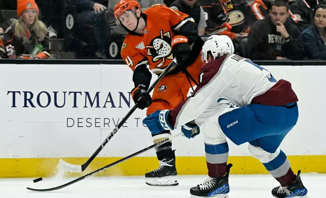 Anaheim Ducks defenseman Ian Moore takes a shot against Colorado Avalanche defenseman Wyatt Aamodt (5) during the first period of an NHL hockey game in Anaheim, Calif., Sunday, April 13, 2025. (AP Photo/Alex Gallardo)