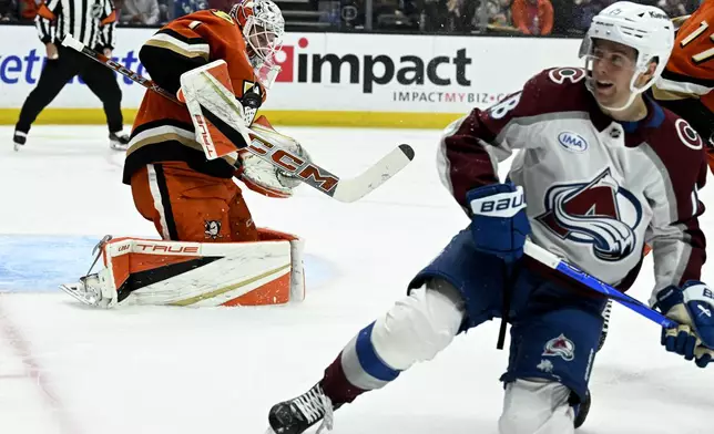 Anaheim Ducks goaltender Lukas Dostal (1) blocks a shot by Colorado Avalanche center Jack Drury (18) during the second period of an NHL hockey game in Anaheim, Calif., Sunday, April 13, 2025. (AP Photo/Alex Gallardo)
