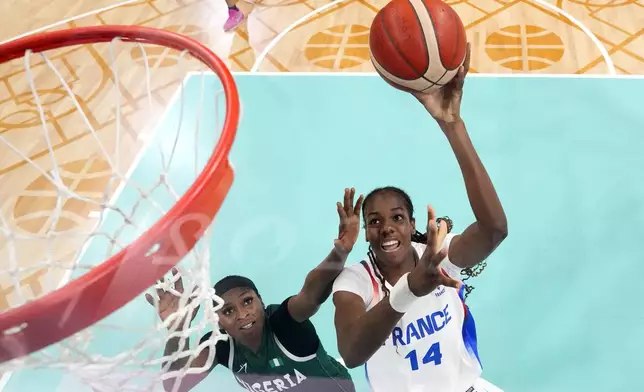 FILE - France's Dominique Malonga, right, shoots as Nigeria's Amy Elizabeth Balogun defends in a women's basketball game at the 2024 Summer Olympics, Aug. 1, 2024, in Villeneuve-d'Ascq, France. (AP Photo/Michael Conroy, Pool File)
