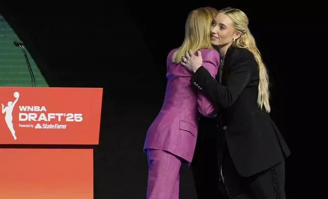 UConn's Paige Bueckers, right, embraces WNBA commissioner Cathy Engelbert after being selected first overall by the Dallas Wings during the first round of the WNBA basketball draft, Monday, April 14, 2025, in New York. (AP Photo/Pamela Smith)