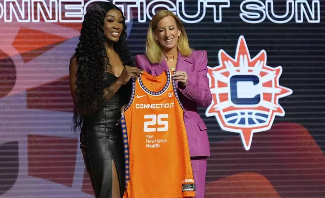 LSU's Aneesah Morrow, left, poses with WNBA commissioner Cathy Engelbert after being selected seventh overall by the Connecticut Sun during the first round of the WNBA basketball draft, Monday, April 14, 2025, in New York. (AP Photo/Pamela Smith)
