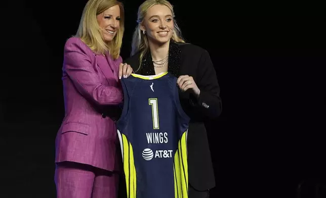 UConn's Paige Bueckers, right, poses for a photo with WNBA commissioner Cathy Engelbert after being selected first overall by the Dallas Wings during the first round of the WNBA basketball draft, Monday, April 14, 2025, in New York. (AP Photo/Pamela Smith)