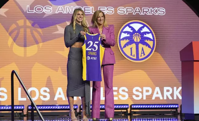 Alabama's Sarah Ashlee Barker, left, poses for a photo with WNBA commissioner Cathy Engelbert after being selected ninth overall by the Los Angeles Sparks during the first round of the WNBA basketball draft, Monday, April 14, 2025, in New York. (AP Photo/Pamela Smith)