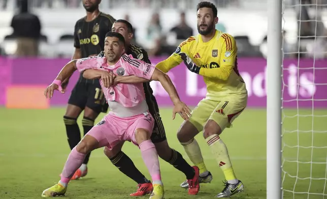 Inter Miami forward Luis Suárez (9) battles for position during a corner kick with Los Angeles FC defender Sergi Palencia (14) as goalkeeper Hugo Lloris (1) looks on during the first half of a CONCACAF Nations League Quarterfinal Match at Chase Stadium, Wednesday, April 9, 2025 in Fort Lauderdale, Fla. (AP Photo/Jim Rassol)