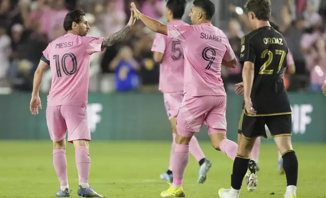 Inter Miami forward Lionel Messi (10) celebrates a goal with forward Luis Suárez (9) against the Los Angeles FC during the first half of a CONCACAF Nations League Quarterfinal Match at Chase Stadium, Wednesday, April 9, 2025 in Fort Lauderdale, Fla. (AP Photo/Jim Rassol)
