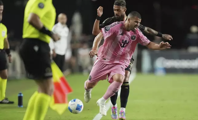 Inter Miami defender Marcelo Weigandt (57) collides with Los Angeles FC forward Denis Bouanga (99) during the first half of a CONCACAF Nations League Quarterfinal Match at Chase Stadium, Wednesday, April 9, 2025 in Fort Lauderdale, Fla. (AP Photo/Jim Rassol)