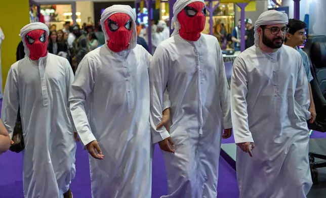 Emirati men wear Spider-Man masks as they attend the Middle East Film &amp; Comic Con in Abu Dhabi, United Arab Emirates, Saturday, April 19, 2025. (AP Photo/ Fatima Shbair)