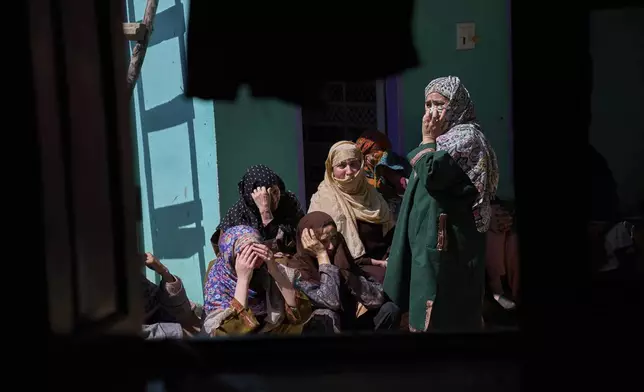 Kashmiri villager women grieve as they sit outside the blown-up family home of Asif Shiekh, a militant who officials say is involved in the deadly attack on tourists in Pahalgam, at Monghama village in Tral, south of Srinagar, Indian controlled Kashmir, Friday, April 25, 2025. (AP Photo/Dar Yasin)