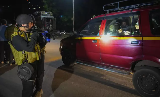 Indian police officers stand guard near Pahalgam in south Kashmir after assailants indiscriminately opened fired at tourists visiting Pahalgam, Indian controlled Kashmir, Tuesday, April 22, 2025.(AP Photo/Dar Yasin)