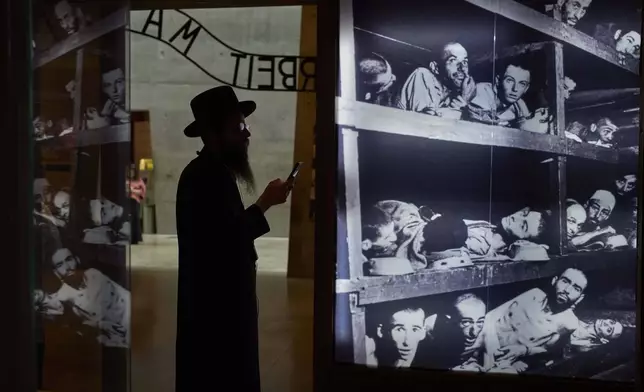 An ultra-Orthodox Jewish man visit the Yad Vashem Holocaust Memorial Museum in Jerusalem, Tuesday, April 22, 2025, ahead of the annual Holocaust remembrance day which begins at sundown Wednesday. (AP Photo/Ohad Zwigenberg)