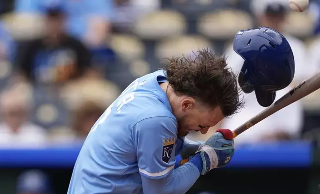 Kansas City Royals' Bobby Witt Jr. is hit by a pitch thrown by Colorado Rockies starting pitcher German Marquez during the first inning of the first game in a baseball doubleheader, Thursday, April 24, 2025, in Kansas City, Mo. (AP Photo/Charlie Riedel)