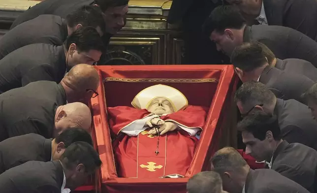 The body of Pope Francis is placed into St. Peter's Basilica at the Vatican, Wednesday, April 23, 2025, where he will lie in state for three days. (AP Photo/Andrew Medichini, Pool)
