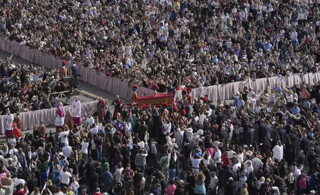 The body of Pope Francis is carried through St. Peter's Square to St. Peter's Basilica at the Vatican, Wednesday, April 23, 2025, where he will lie in state for three days. (AP Photo/Markus Schreiber)