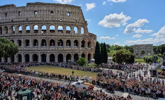 The coffin of Pope Francis passes the Colosseum in Rome, Saturday, April 26, 2025. (AP Photo/Bernat Armangue)