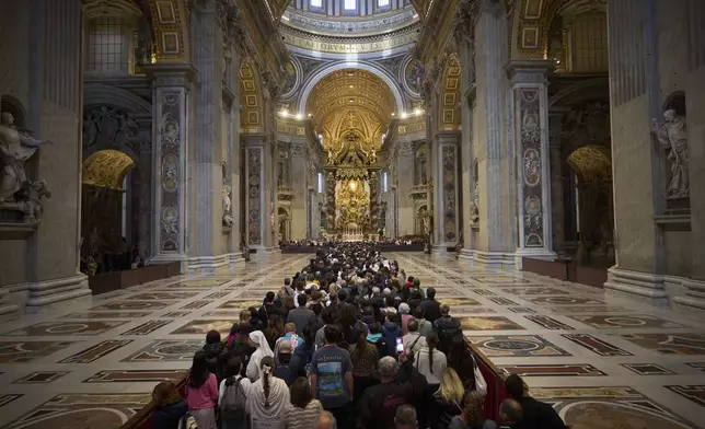 People line up as they enter St. Peter's Basilica to pay their respects to Pope Francis lying in state, at the Vatican, Thursday, April 24, 2025. (AP Photo/Emilio Morenatti)