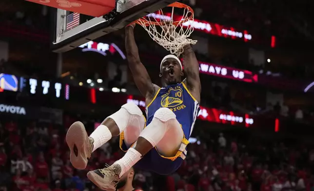 Golden State Warriors forward Jimmy Butler III (10) dunks during the second half of Game 1 of an NBA basketball first-round playoff series against the Houston Rockets in Houston, Sunday, April 20, 2025. (AP Photo/Ashley Landis)