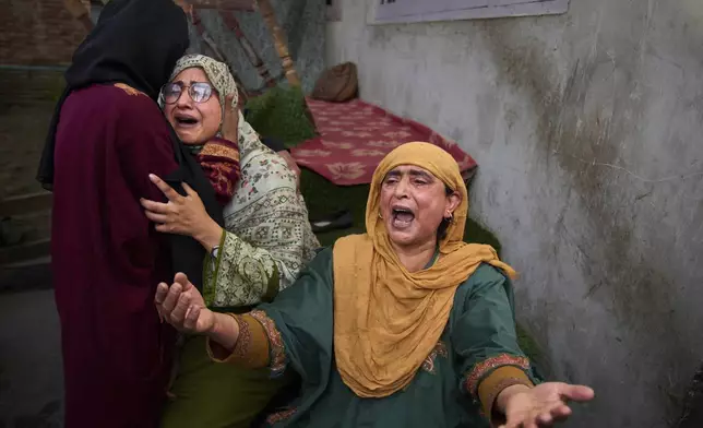 Relatives of Ahsan Ul Haq Shiekh, a militant who officials say is involved in the deadly attack on tourists in Pahalgam, wail after after Indian forces blew up the family home at Murran village in Pulwama, south of Srinagar, Indian controlled Kashmir, Saturday, April 26, 2025. (AP Photo/Dar Yasin)