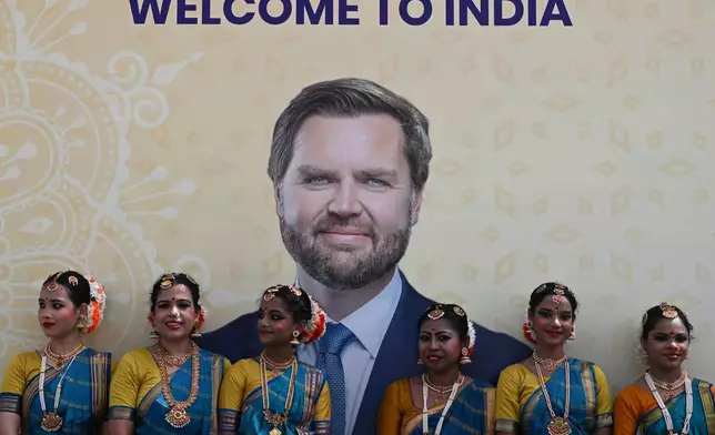 A poster of U.S. Vice President JD Vance is displayed as he arrives in New Delhi, India, Monday, April 21, 2025. (Kenny Holston/The New York Times via AP, Pool)