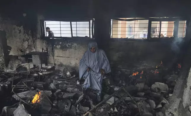 Palestinians inspect the damage after an Israeli army airstrike on Yaffa School, in Gaza City, Wednesday, April 23, 2025. (AP Photo/Jehad Alshrafi)