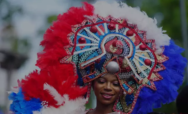 A woman in costume dances on the street during the Fanti Carnival in Lagos Nigeria, Sunday, April 20, 2025. (AP Photo/Sunday Alamba)