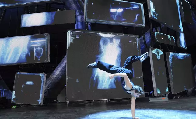 Dancer Diego Pasillas warms up in front of onstage video screens during rehearsals for Katy Perry's "The Lifetimes Tour" at the Toyota Arena on Wednesday, April 9, 2025, in Ontario, Calif. (AP Photo/Chris Pizzello)