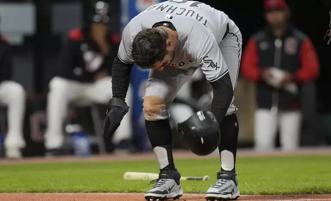 Chicago White Sox's Mike Tauchman slams his helmet down after being tagged out by Cleveland Guardians catcher Austin Hedges in the ninth inning of a baseball game in Cleveland, Wednesday, April 9, 2025. (AP Photo/Sue Ogrocki)