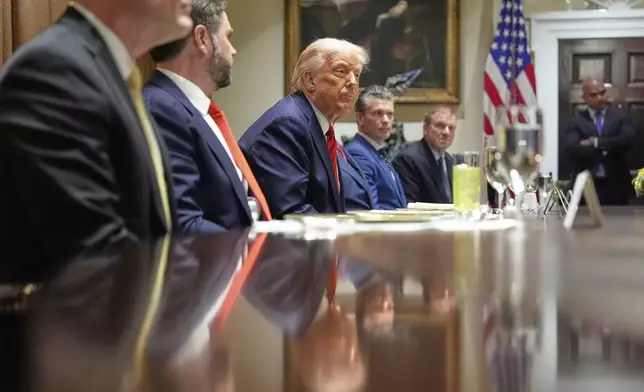 President Donald Trump listens before a luncheon with Italy's Prime Minister Giorgia Meloni in the Cabinet Room of the White House, Thursday, April 17, 2025, in Washington. (AP Photo/Alex Brandon)