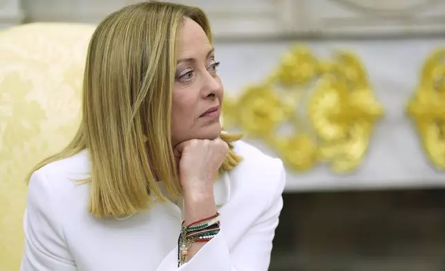 Italy's Prime Minister Giorgia Meloni listens as she meets with President Donald Trump in the Oval Office of the White House, Thursday, April 17, 2025, in Washington. (AP Photo/Alex Brandon)