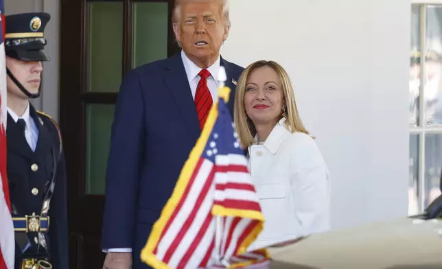 President Donald Trump, center, greets Italy's Prime Minister Giorgia Meloni, right, upon her arrival at the White House, Thursday, April 17, 2025, in Washington. (AP Photo/Tom Brenner)