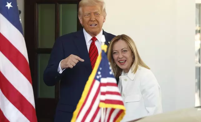 President Donald Trump, left, greets Italy's Prime Minister Giorgia Meloni upon her arrival at the White House, Thursday, April 17, 2025, in Washington. (AP Photo/Tom Brenner)