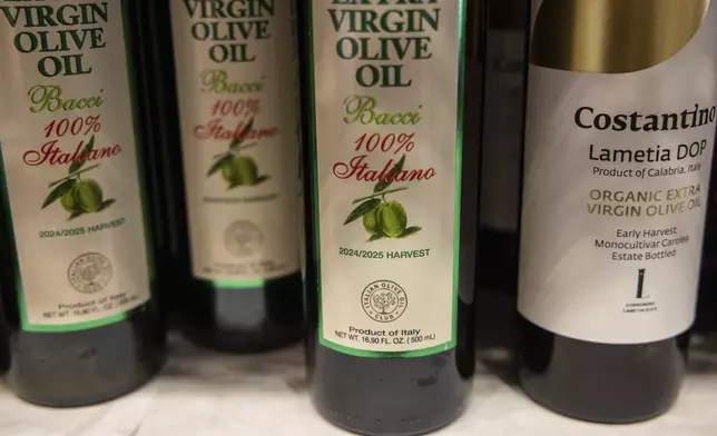 Bottles of olive oil produced in Italy are displayed at Italian grocery store in the Little Italy neighborhood, Wednesday, April 9, 2025, in New York. (AP Photo/Yuki Iwamura)