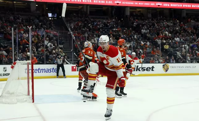 Calgary Flames center Mikael Backlund celebrates after scoring against the Anaheim Ducks during the second period of an NHL hockey game, Wednesday, April 9, 2025, in Anaheim, Calif. (AP Photo/Etienne Laurent)