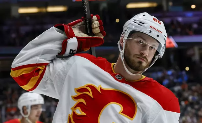 Calgary Flames winger Joel Farabee reacts after missing an attempt to score against Anaheim Ducks during the second period of an NHL hockey game, Wednesday, April 9, 2025, in Anaheim, Calif. (AP Photo/Etienne Laurent)