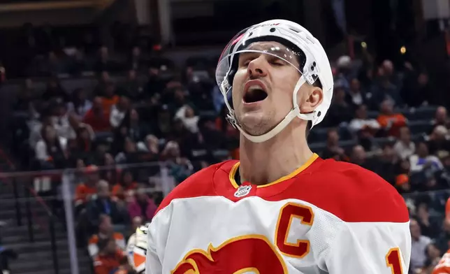 Calgary Flames center Mikael Backlund celebrates after scoring against the Anaheim Ducks during the second period of an NHL hockey game, Wednesday, April 9, 2025, in Anaheim, Calif. (AP Photo/Etienne Laurent)