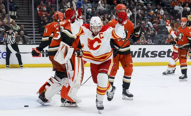 Calgary Flames center Mikael Backlund celebrates after scoring against the Anaheim Ducks during the second period of an NHL hockey game, Wednesday, April 9, 2025, in Anaheim, Calif. (AP Photo/Etienne Laurent)