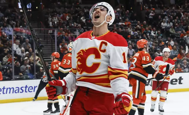 Calgary Flames center Mikael Backlund celebrates after scoring against the Anaheim Ducks during the second period of an NHL hockey game, Wednesday, April 9, 2025, in Anaheim, Calif. (AP Photo/Etienne Laurent)