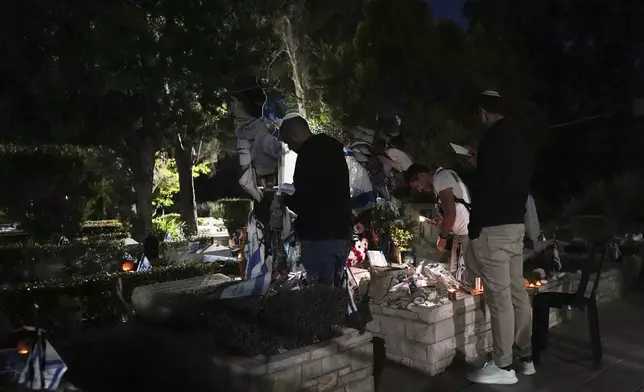 People visit Mount Herzl military cemetery in Jerusalem on the eve of Israel's annual Memorial Day for the fallen soldiers, Tuesday, April 29, 2025. (AP Photo/Ohad Zwigenberg)