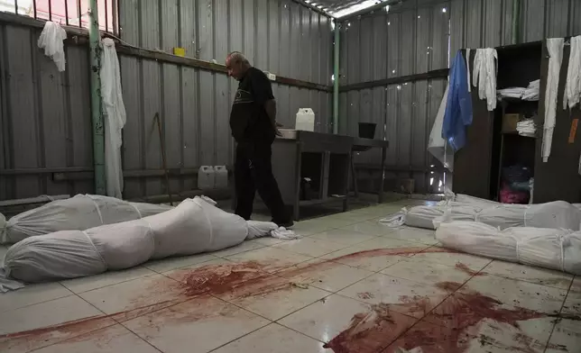 The bodies of several members of the Abu Mahdi family, killed in an Israeli army airstrike, lie on the floor at the Indonesian hospital in Beit Lahia, northern Gaza Strip, Monday, April 28, 2025. (AP Photo/Jehad Alshrafi)