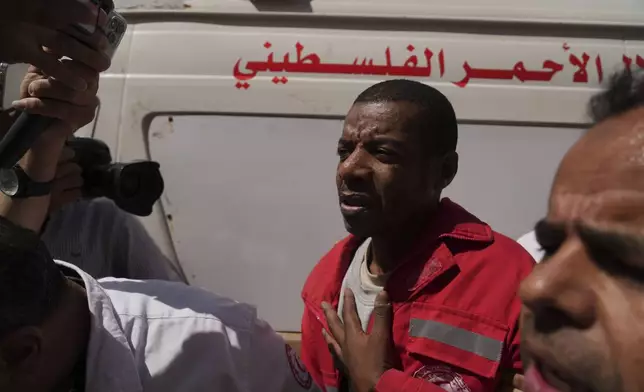 Asaad Al-Nsasrah, a paramedic with the Red Crescent whose colleagues were killed by Israeli army in southern Gaza, arrives at al-Aqsa Hospital in Deir al-Balah, central Gaza, on Tuesday, April 29, 2025, after being released from an Israeli prison. (AP Photo/Abdel Kareem Hana)