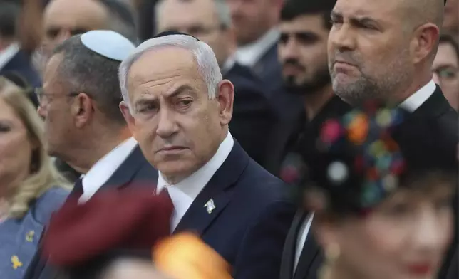 Israeli Prime Minister Benjamin Netanyahu, center, Speaker of the Israeli Knesset, Amir Ohana, right, and Jerusalem mayor Moshe Leon, left, attend the annual ceremony at the eve of Israel's Remembrance Day for fallen soldiers at the Yad LaBanim Memorial in Jerusalem, on Tuesday, April 29, 2025. (Abir Sultan/Pool Photo via AP)