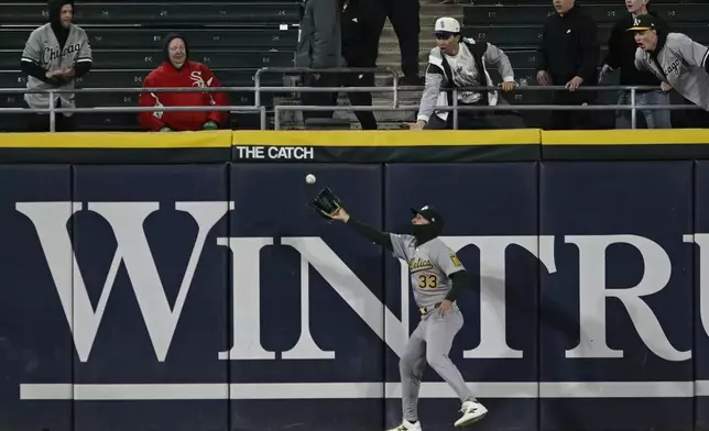 Athletics center fielder JJ Bleday (33) catches a fly ball hit by Chicago White Sox's Brooks Baldwin during the fourth inning of a baseball game Wednesday, April 16, 2025, in Chicago. (AP Photo/Paul Beaty)