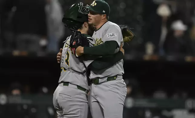 Athletics closing pitcher Mason Miller right, celebrates with catcher Shea Langeliers left, after defeating the Chicago White Sox in a baseball game Wednesday, April 16, 2025, in Chicago. (AP Photo/Paul Beaty)
