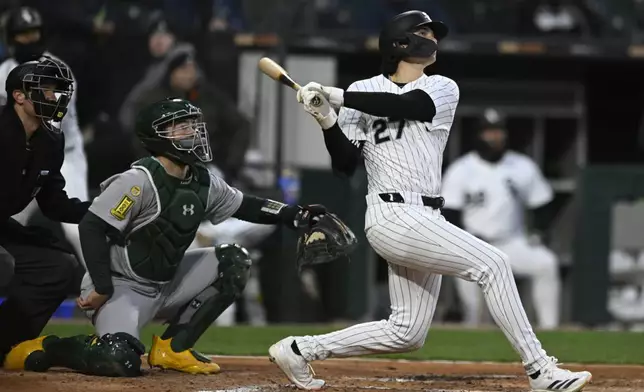 Chicago White Sox's Brooks Baldwin (27) watches his solo home run during the third inning of a baseball game against the Athletics Wednesday, April 16, 2025, in Chicago. (AP Photo/Paul Beaty)