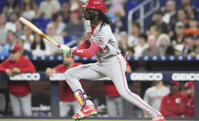 Cincinnati Reds' Elly De La Cruz follows through on a single during the sixth inning of a baseball game against the Miami Marlins, Tuesday, April 22, 2025, in Miami. (AP Photo/Lynne Sladky)