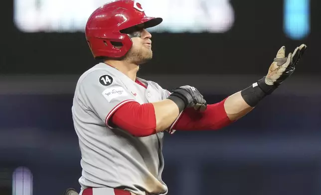 Cincinnati Reds' TJ Friedl reacts after hitting a double during the fifth inning of a baseball game against the Miami Marlins, Tuesday, April 22, 2025, in Miami. (AP Photo/Lynne Sladky)