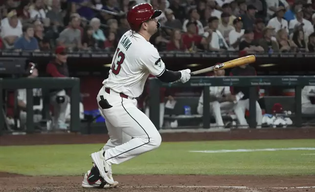 Arizona Diamondbacks' Tim Tawa hits an RBI sacrifice fly out against the Milwaukee Brewers in the sixth inning during a baseball game, Sunday, April 13, 2025, in Phoenix. (AP Photo/Rick Scuteri)