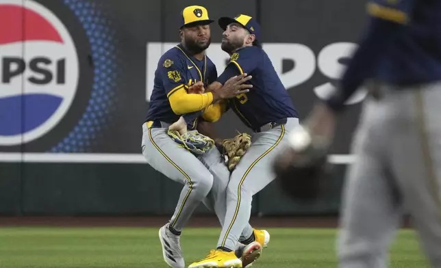 Milwaukee Brewers outfielder Garrett Mitchell (5) and outfielder Sal Frelick collide in the sixth inning on a ball hit by Arizona Tim Tawa during a baseball game, Sunday, April 13, 2025, in Phoenix. (AP Photo/Rick Scuteri)