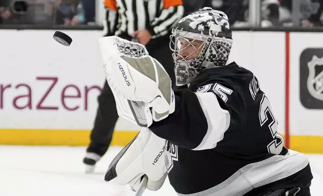 Los Angeles Kings goaltender Darcy Kuemper deflects a shot during the first period in Game 5 of an NHL hockey first-round playoff series against the Edmonton Oilers, Tuesday, April 29, 2025, in Los Angeles. (AP Photo/Mark J. Terrill)