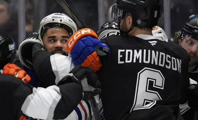 Edmonton Oilers left wing Evander Kane, left, and Los Angeles Kings defenseman Joel Edmundson scuffle during the first period in Game 5 of an NHL hockey first-round playoff series Tuesday, April 29, 2025, in Los Angeles. (AP Photo/Mark J. Terrill)